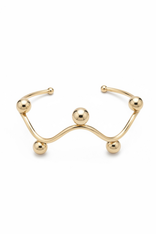 Brazalete rígido ondulado con diseños de esferas